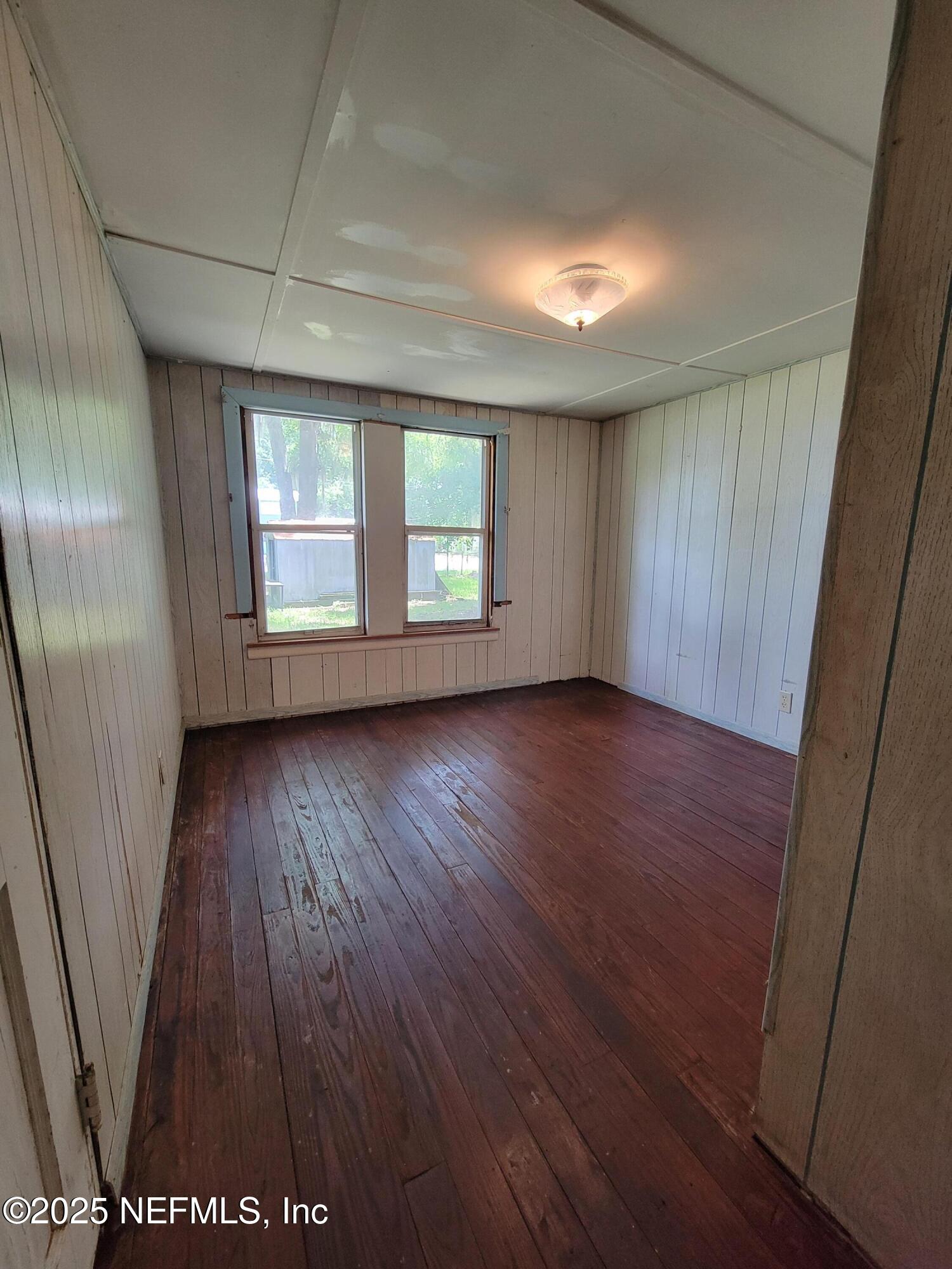 762 North Walnut Street Starke, FL 32091 - Photo 28 of 38 an empty room with wooden floor and windows