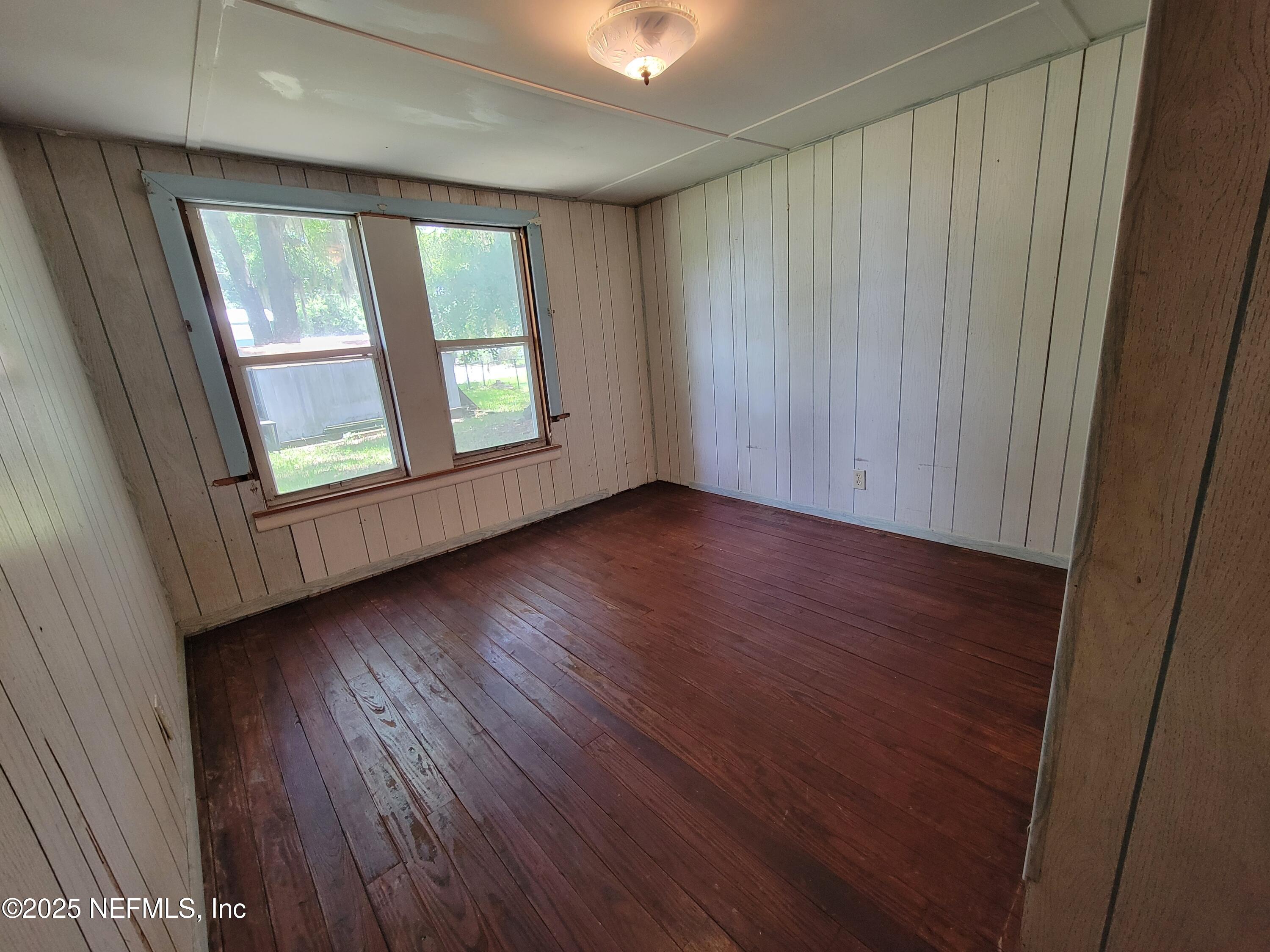 762 North Walnut Street Starke, FL 32091 - Photo 29 of 38 an empty room with wooden floor and windows