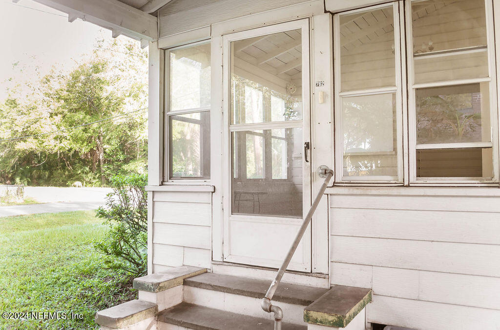 762 North Walnut Street Starke, FL 32091 - Photo 5 of 38 a view of porch with a large window and front view of a house