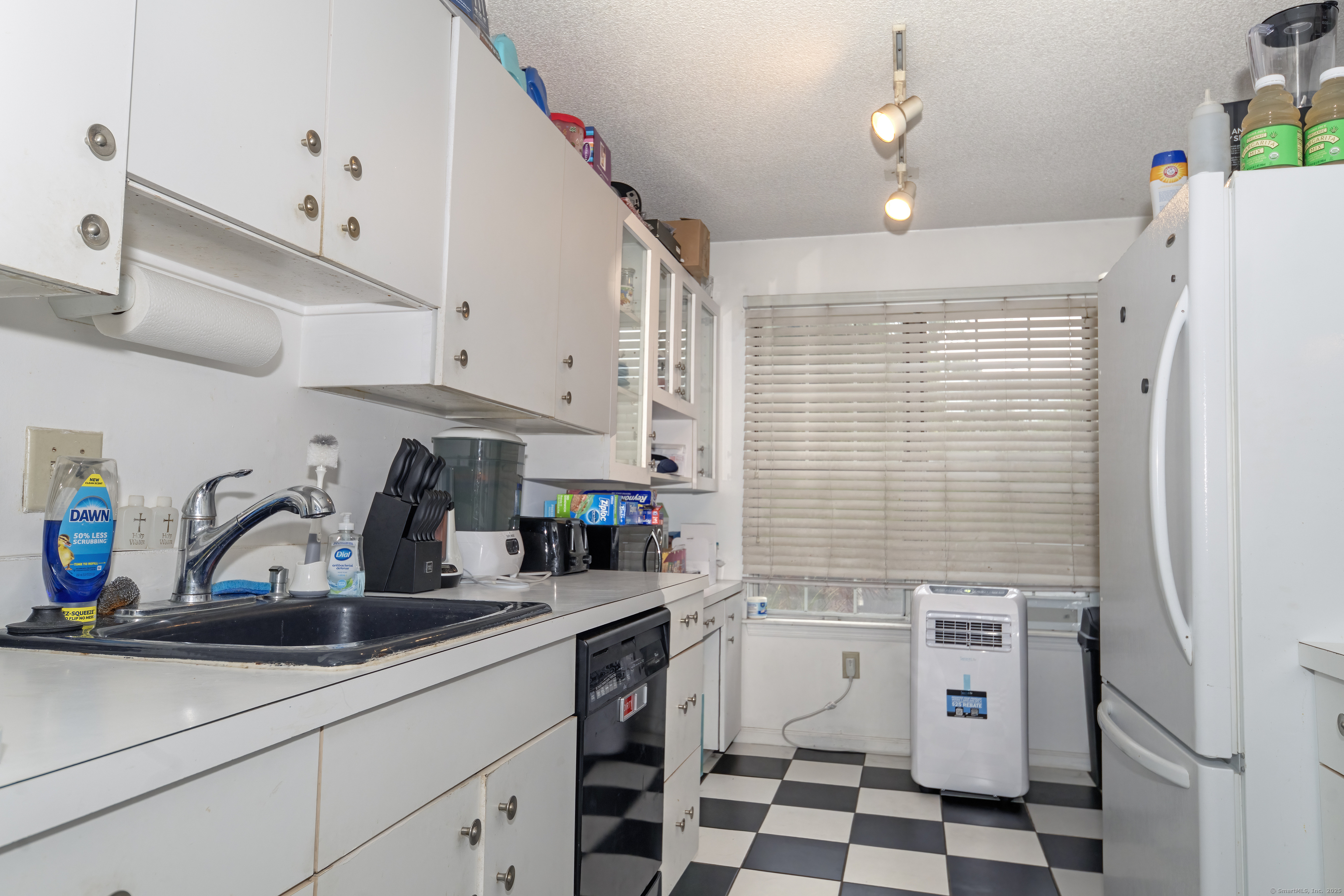 53 Brushy Plain Road, Unit 4E Branford, CT 06405 - Photo 12 of 24 a kitchen with a sink a refrigerator and cabinets