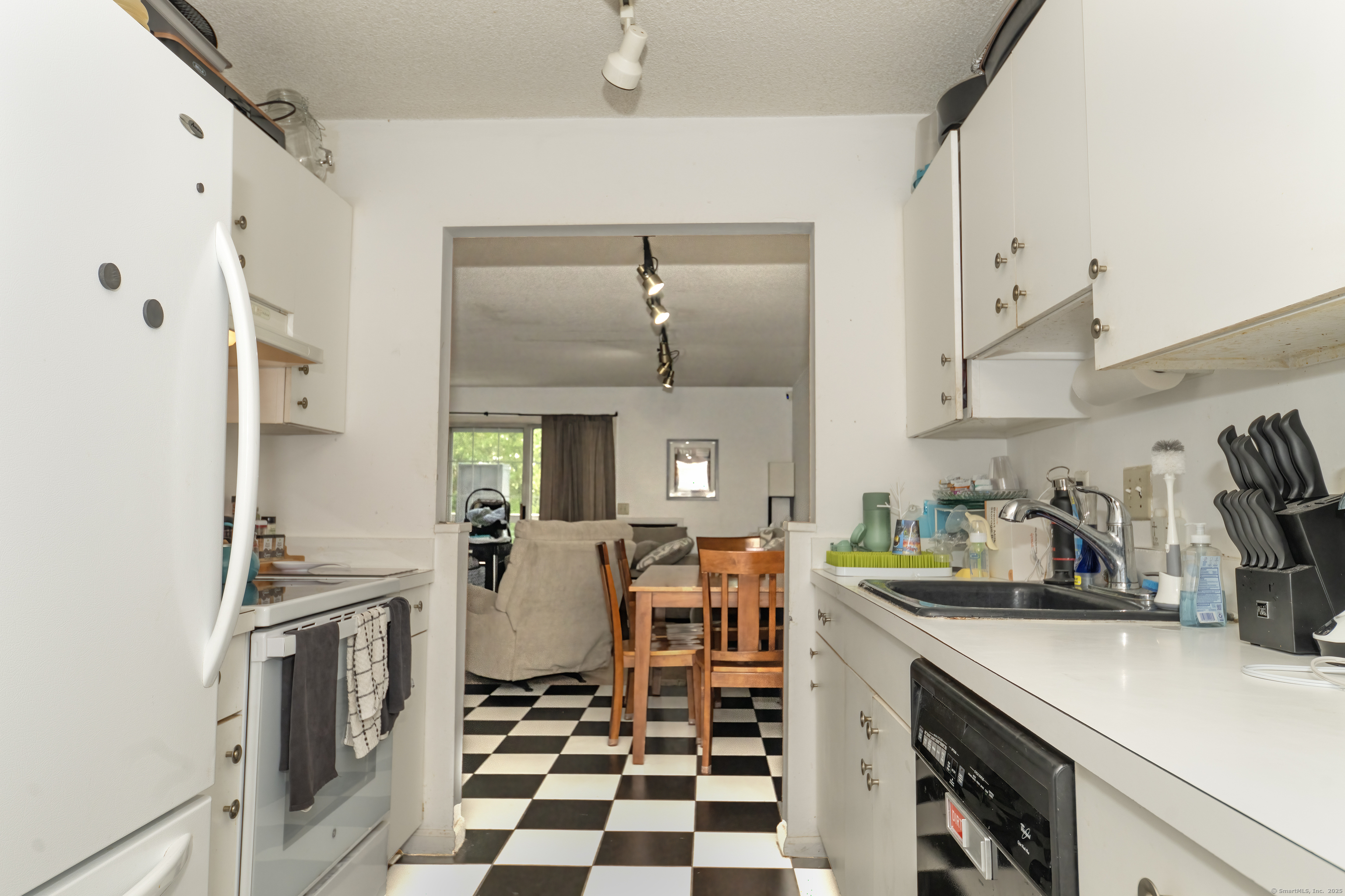 53 Brushy Plain Road, Unit 4E Branford, CT 06405 - Photo 13 of 24 a kitchen with stainless steel appliances a refrigerator a sink a stove and white cabinets