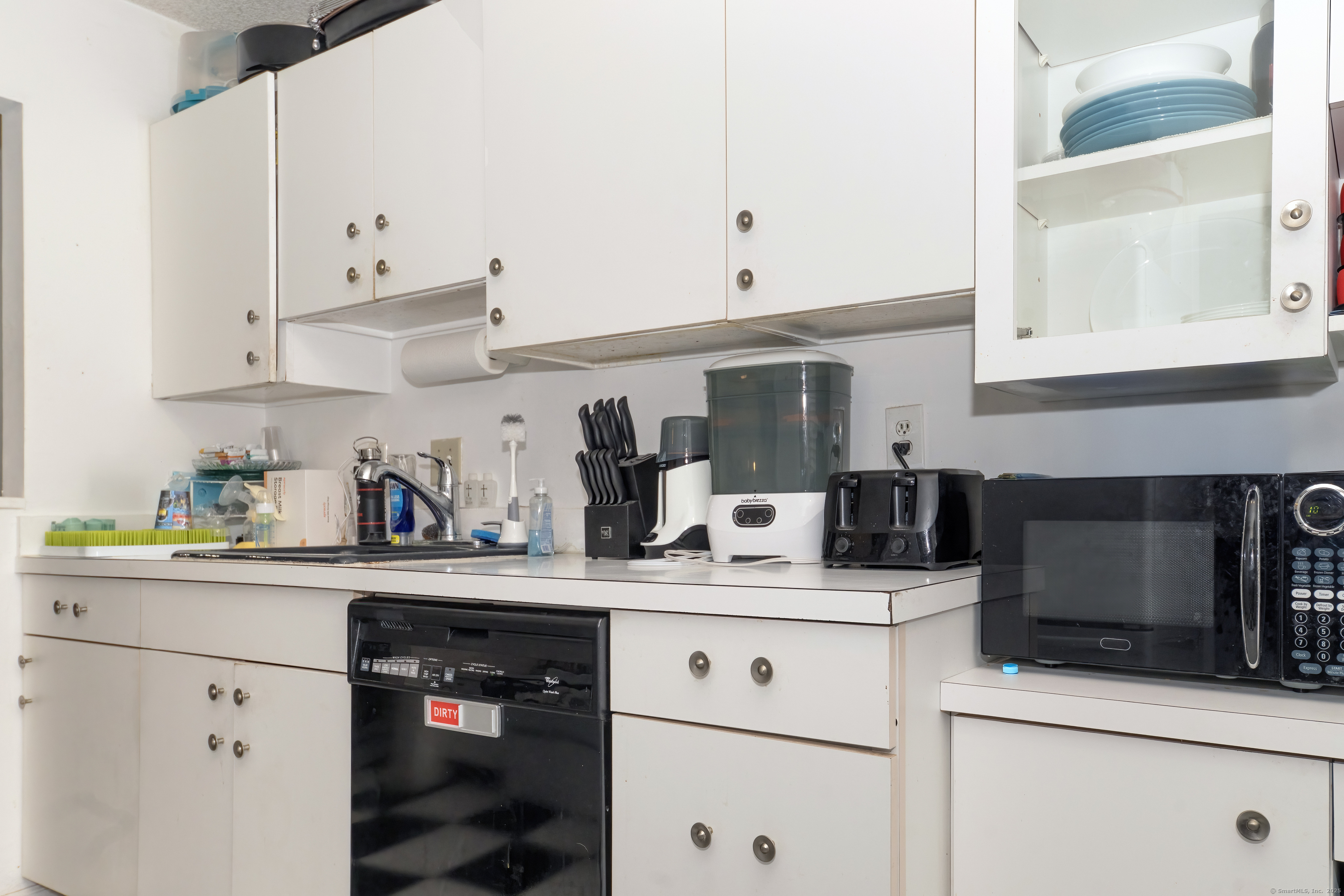 53 Brushy Plain Road, Unit 4E Branford, CT 06405 - Photo 14 of 24 a kitchen with stainless steel appliances granite countertop a sink a stove and white cabinets