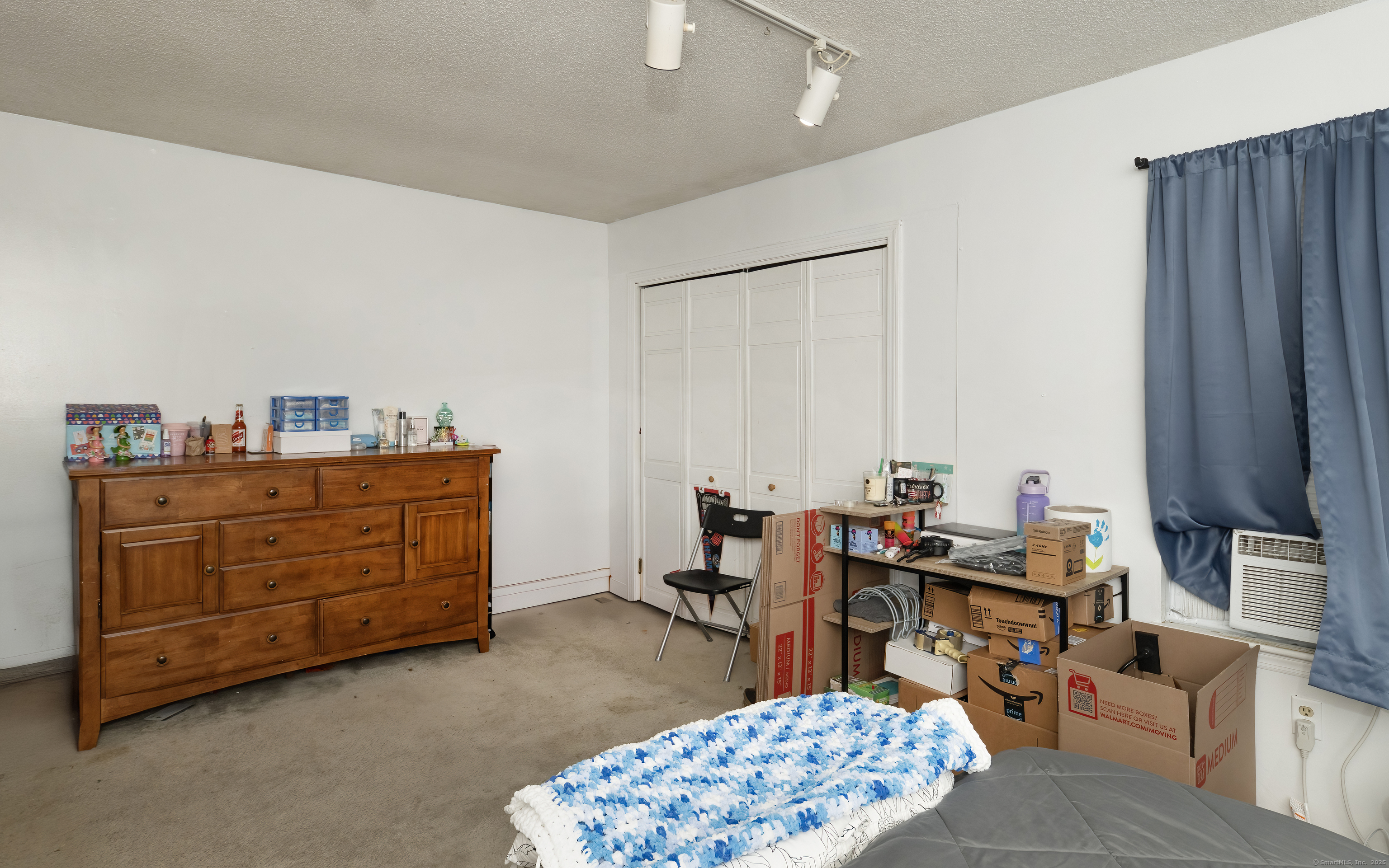 53 Brushy Plain Road, Unit 4E Branford, CT 06405 - Photo 19 of 24 a bedroom with furniture and a dresser