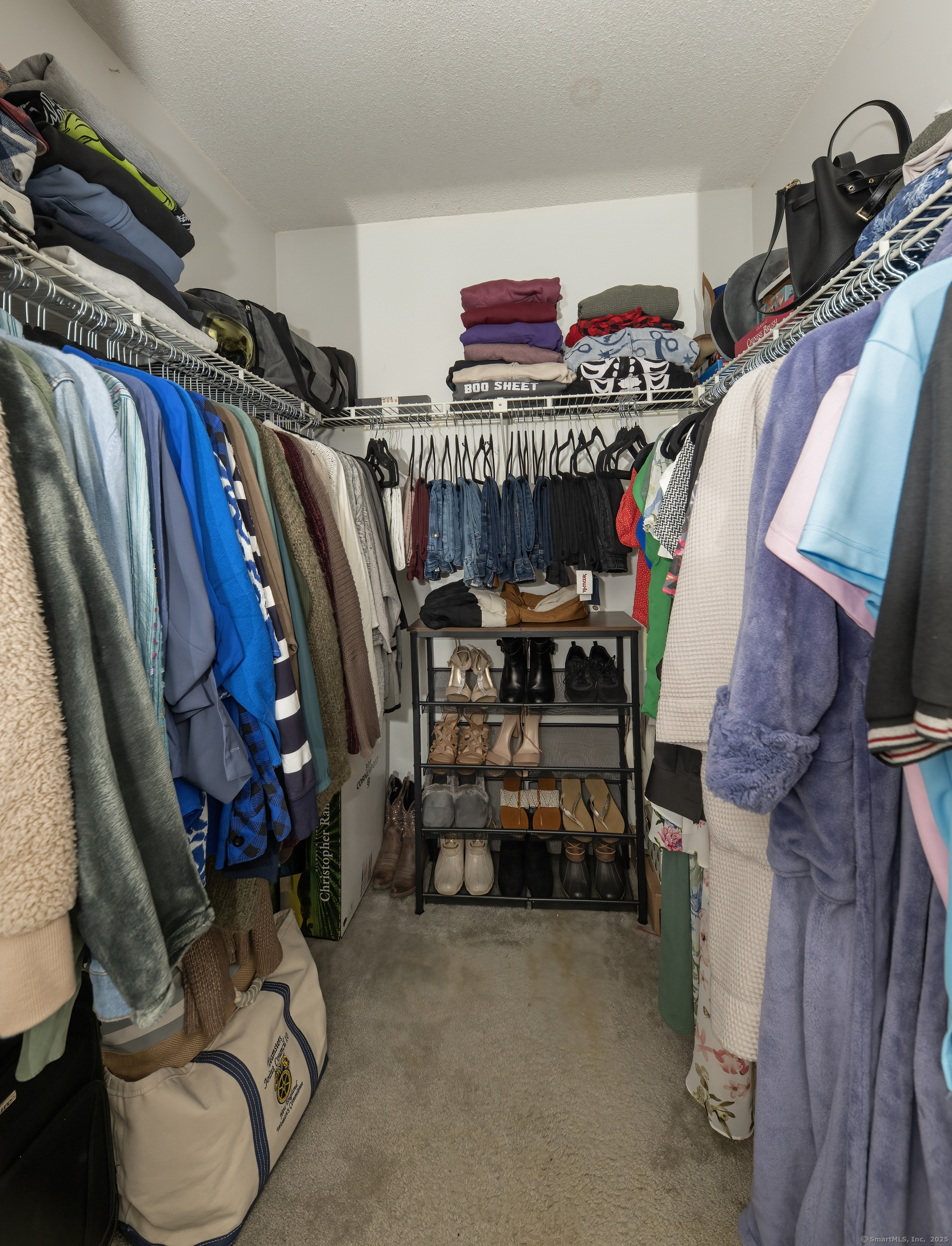 53 Brushy Plain Road, Unit 4E Branford, CT 06405 - Photo 20 of 24 a view of walk in closet with clothes and shoes