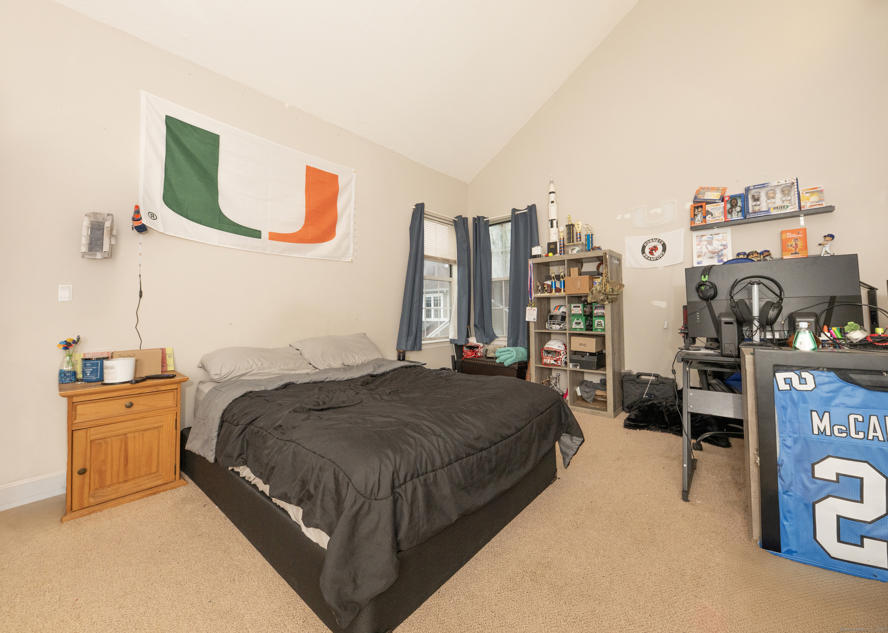 53 Brushy Plain Road, Unit 4E Branford, CT 06405 - Photo 21 of 24 a bed room with a bed and a television