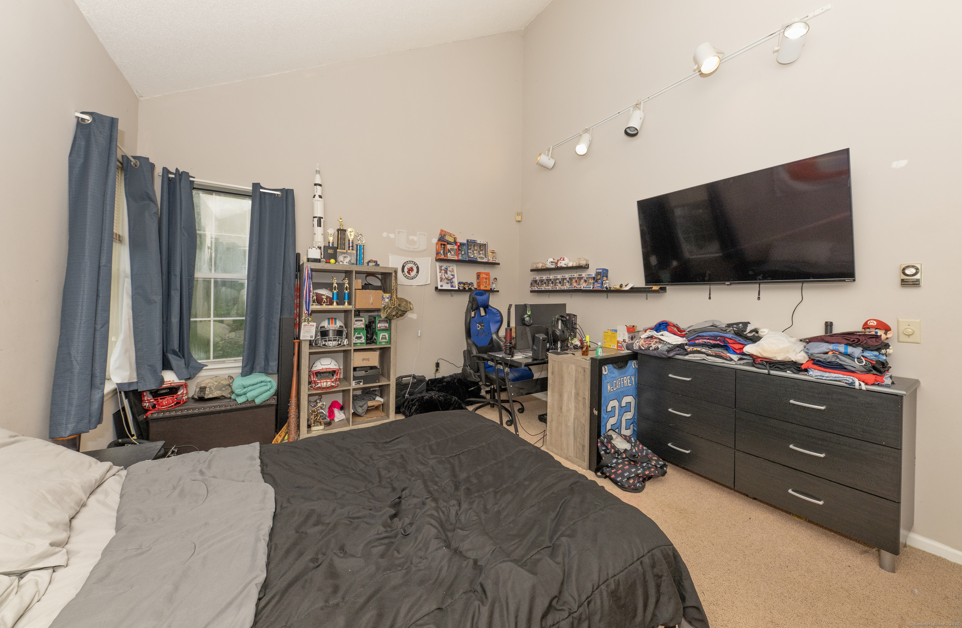 53 Brushy Plain Road, Unit 4E Branford, CT 06405 - Photo 22 of 24 a bed room with a bed and a flat screen tv