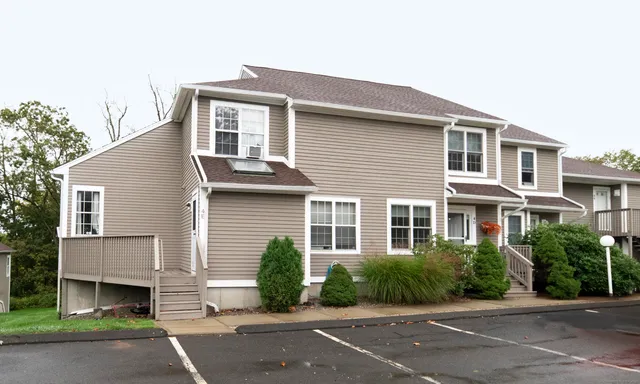 a front view of a house with a garden