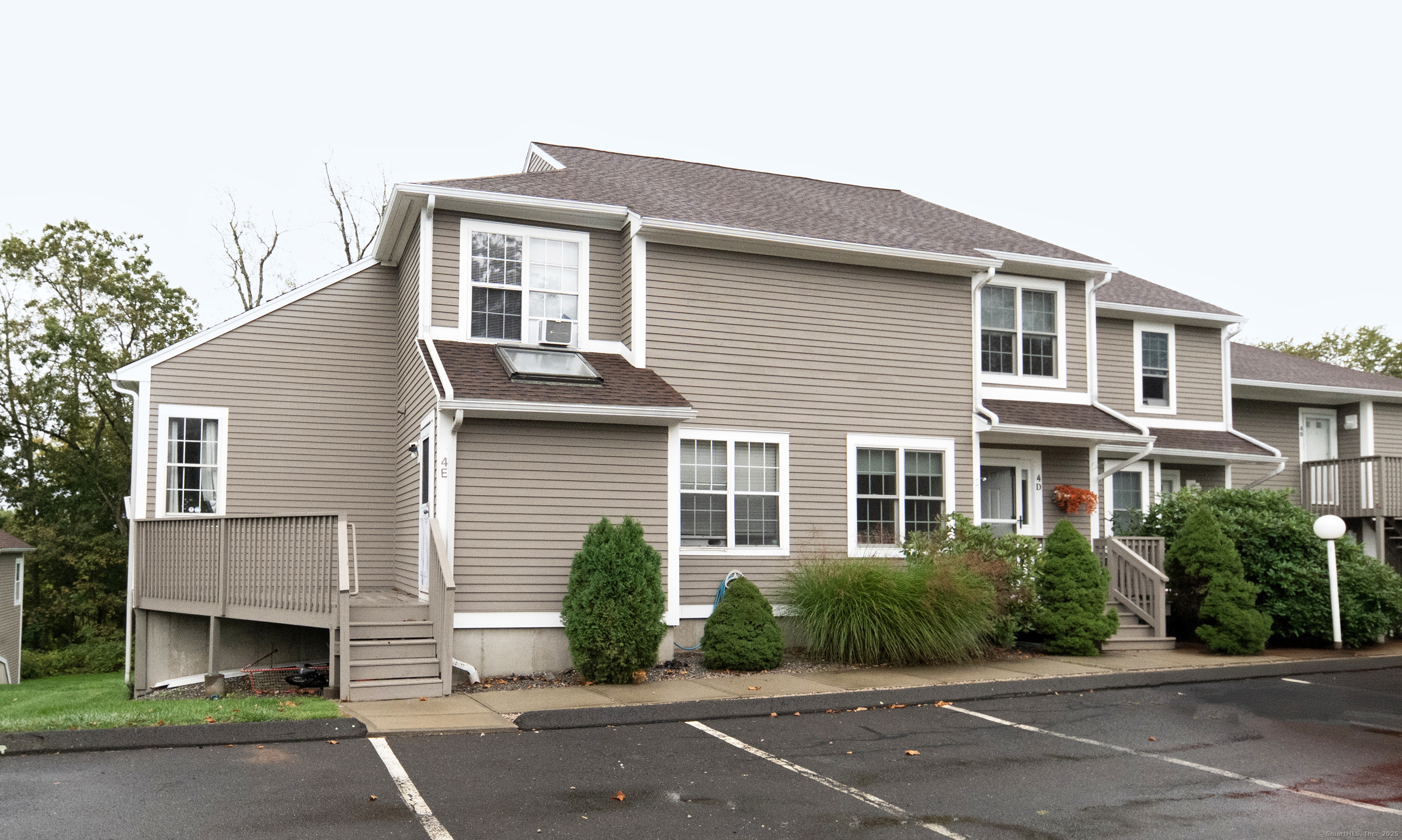 53 Brushy Plain Road, Unit 4E Branford, CT 06405 - Photo 4 of 24 a front view of a house with a garden