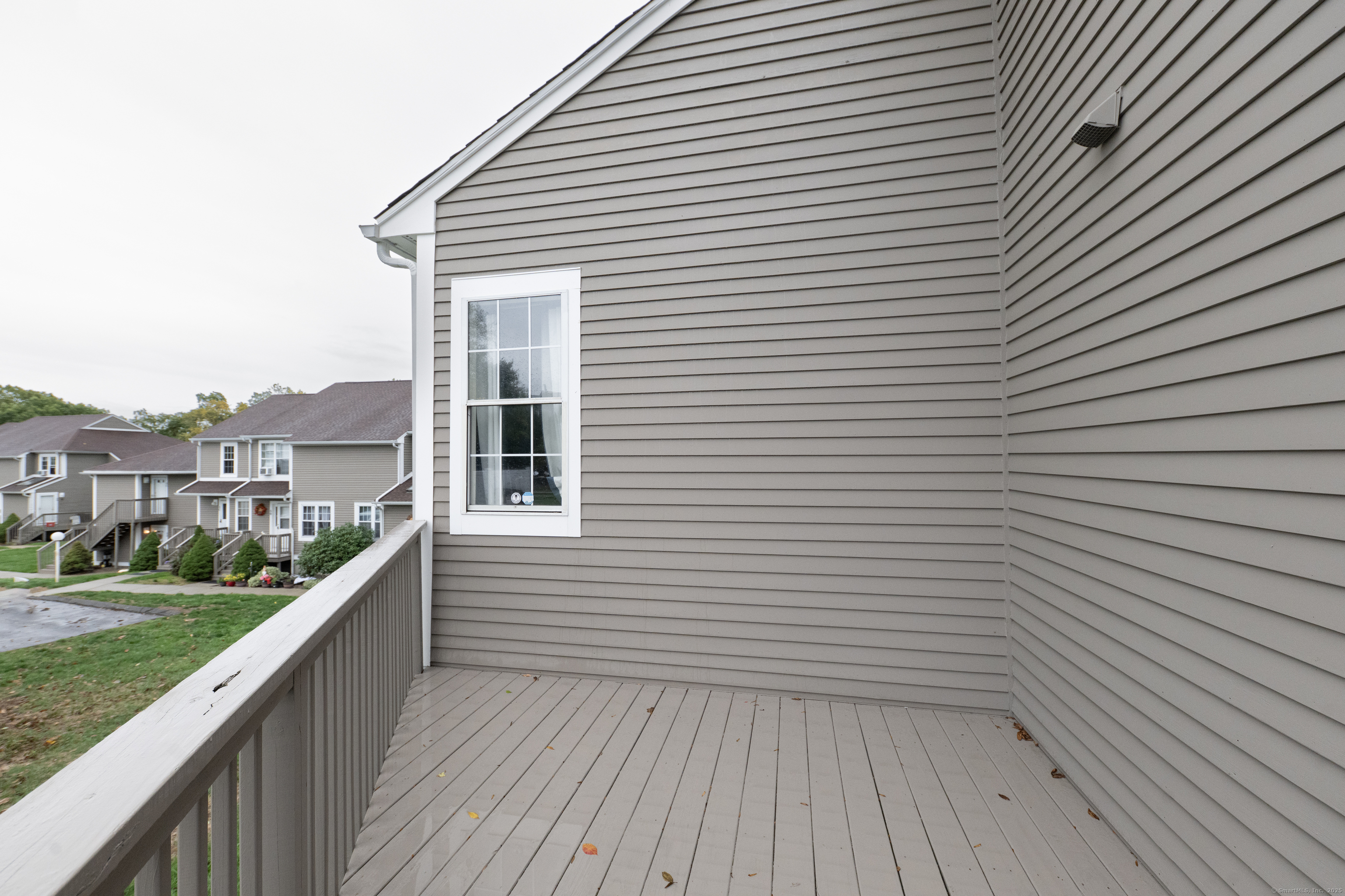 53 Brushy Plain Road, Unit 4E Branford, CT 06405 - Photo 7 of 24 a view of a balcony with wooden floor