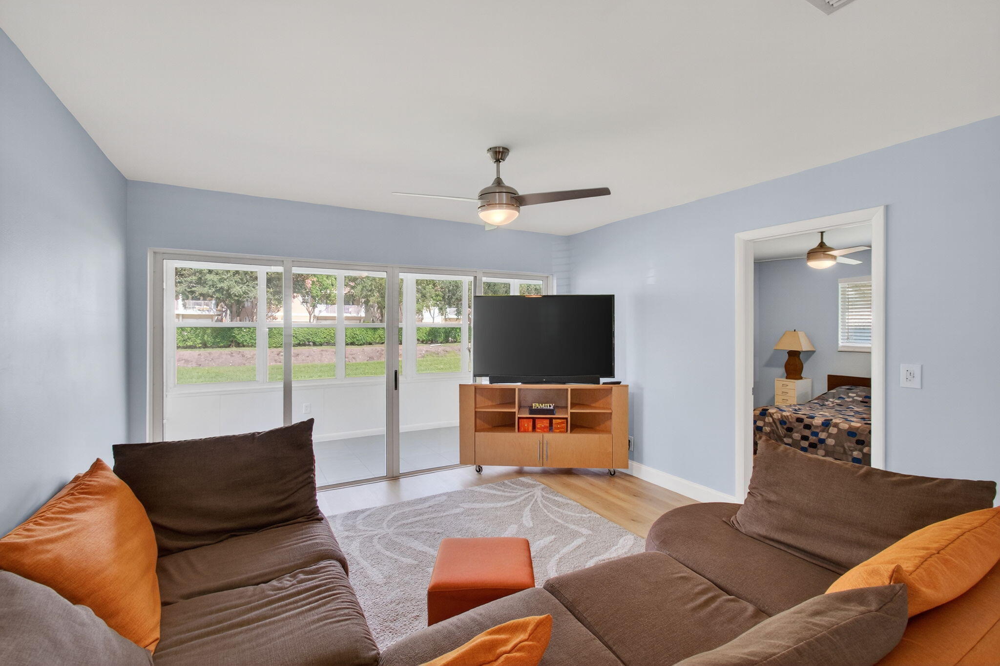 632 Hummingbird Lane Delray Beach, FL 33445 - Photo 12 of 60 a living room with furniture and a flat screen tv