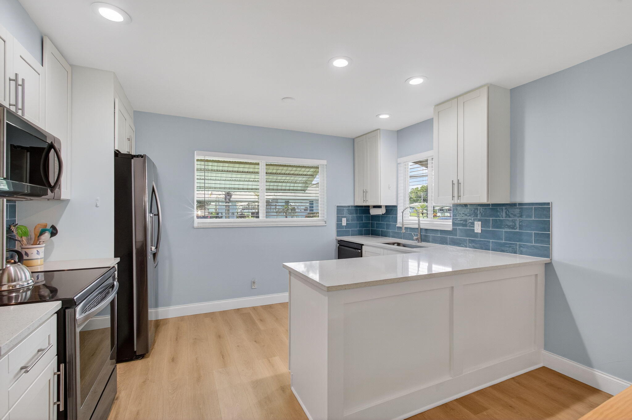 632 Hummingbird Lane Delray Beach, FL 33445 - Photo 17 of 60 a kitchen with a sink stove and refrigerator