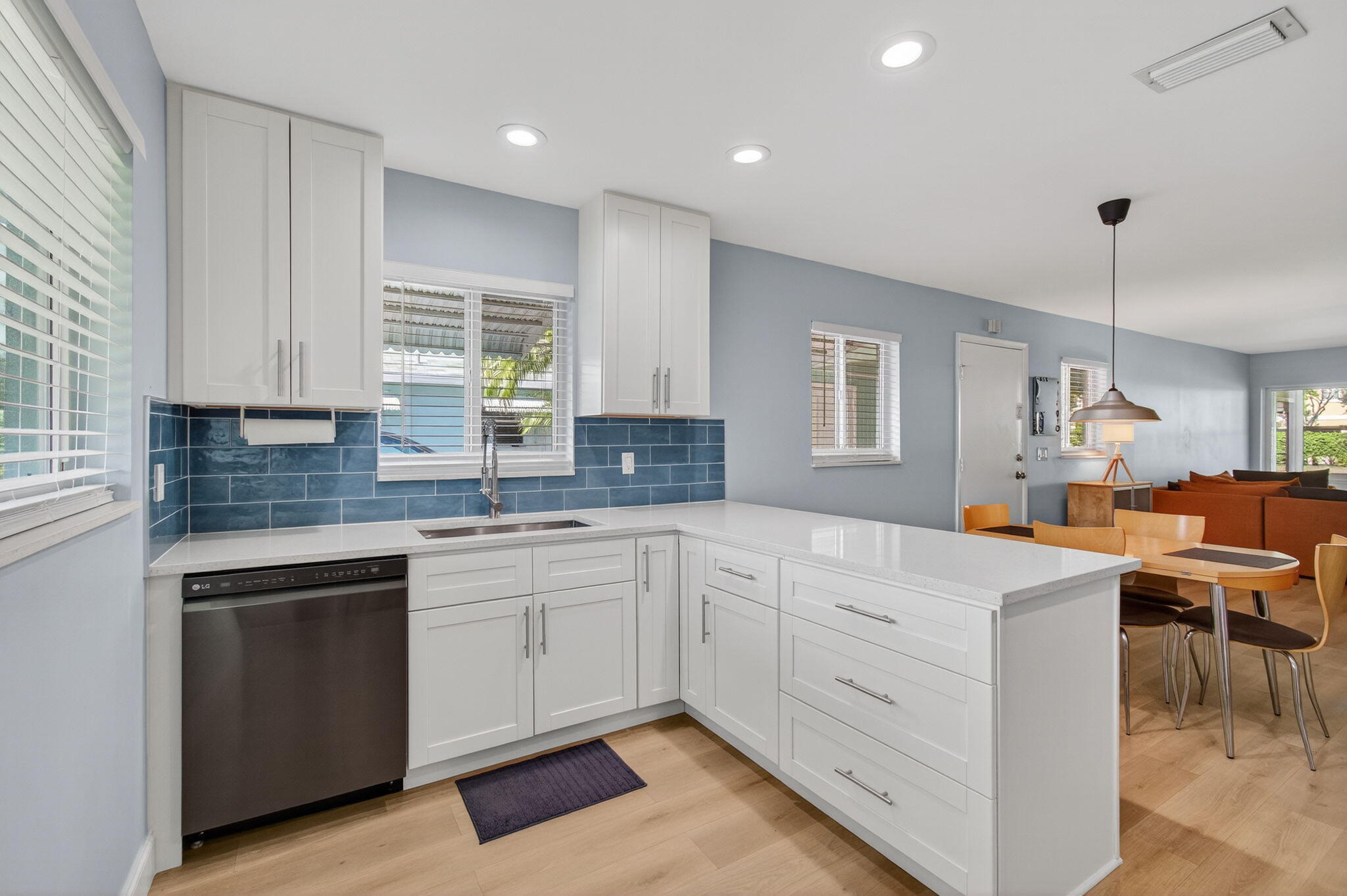 632 Hummingbird Lane Delray Beach, FL 33445 - Photo 21 of 60 a kitchen that has a lot of cabinets in it with granite countertop wooden cabinets