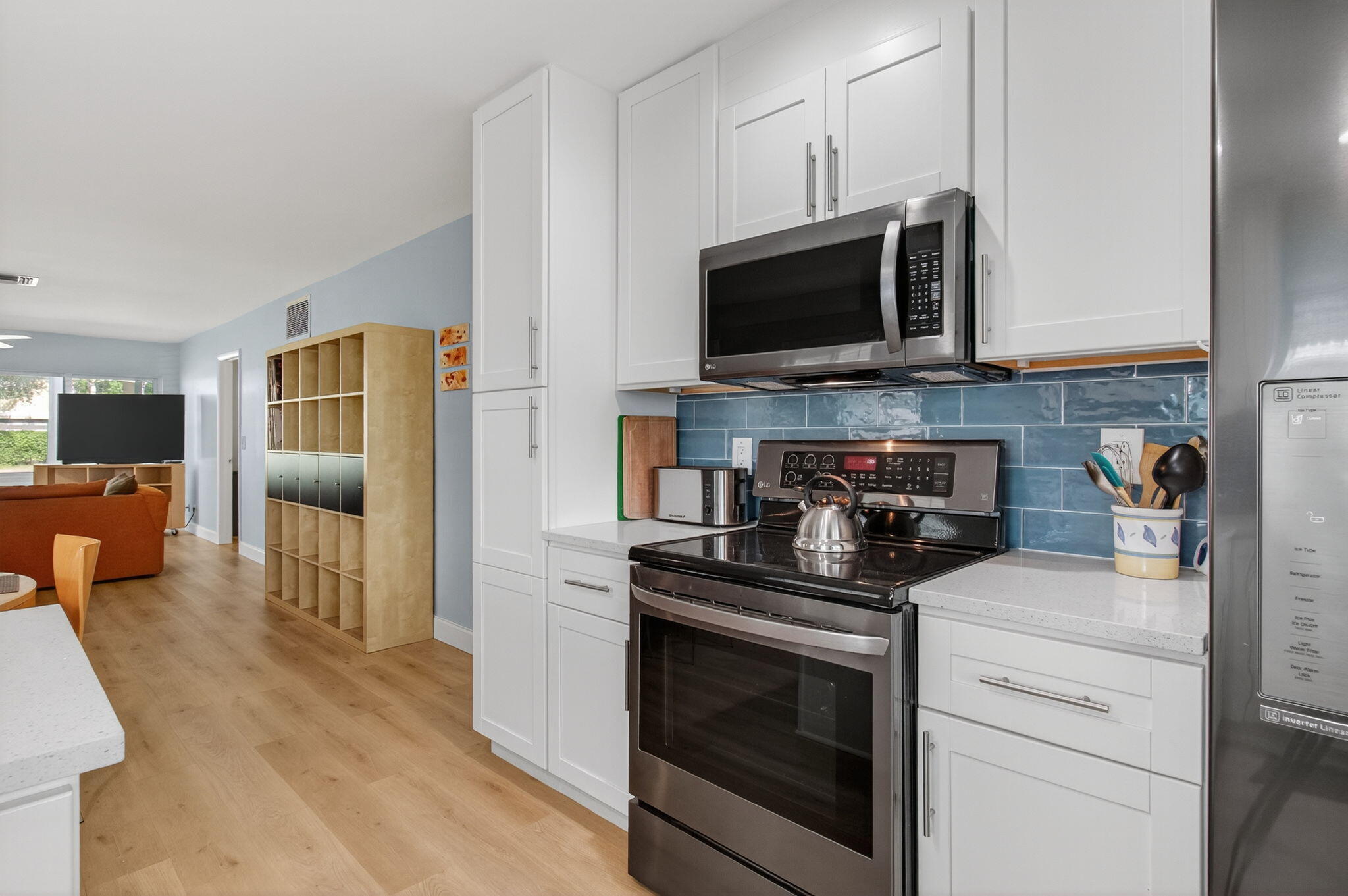 632 Hummingbird Lane Delray Beach, FL 33445 - Photo 23 of 60 a kitchen with stainless steel appliances granite countertop a stove and a microwave