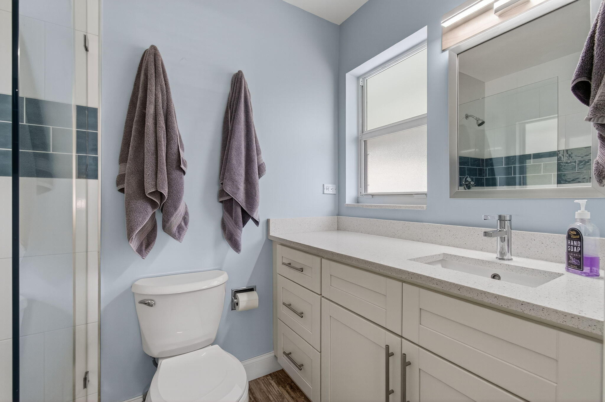 632 Hummingbird Lane Delray Beach, FL 33445 - Photo 36 of 60 a bathroom with a toilet sink and mirror