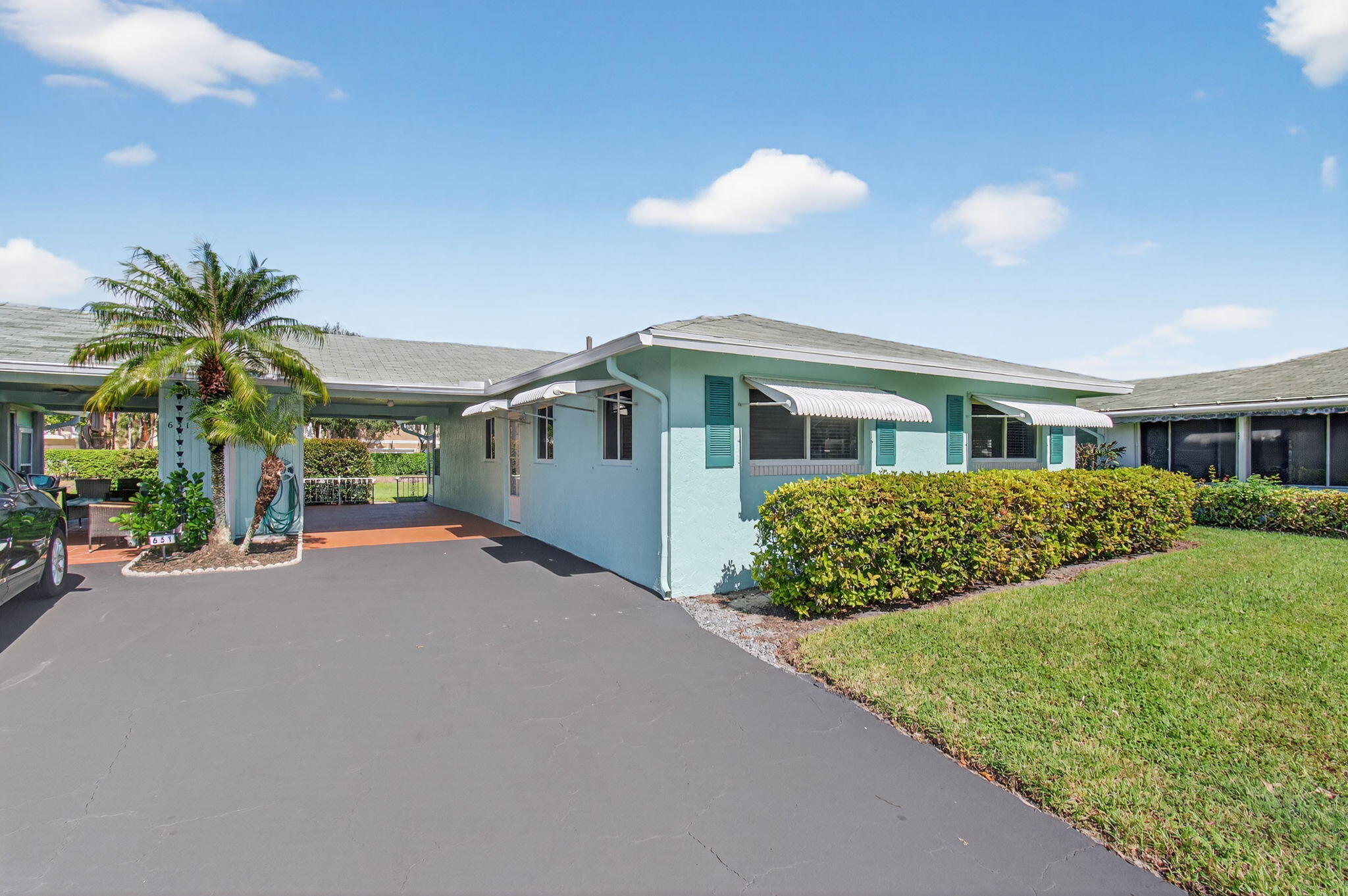 632 Hummingbird Lane Delray Beach, FL 33445 - Photo 4 of 60 a front view of house with yard and trees in the background
