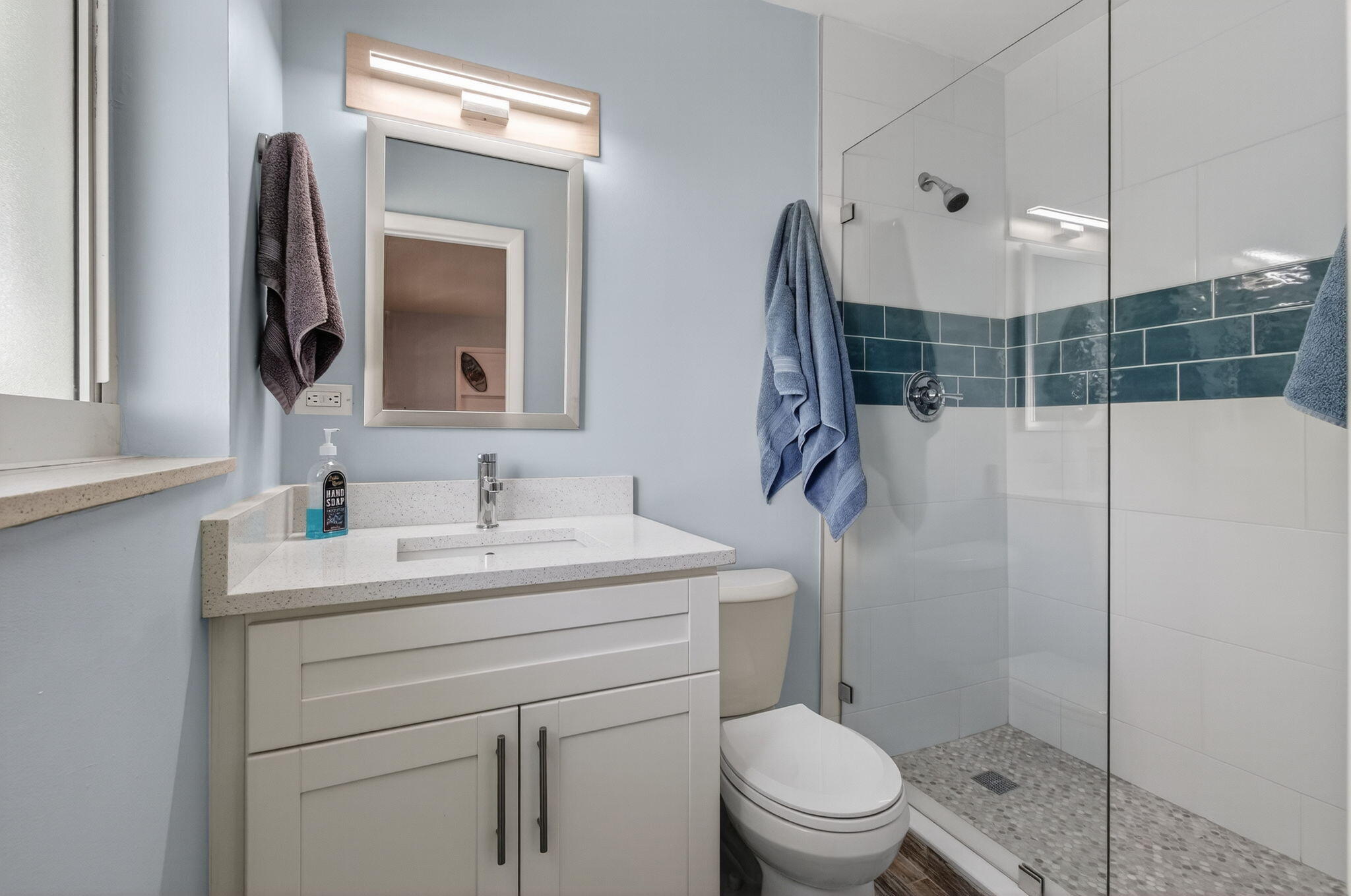 632 Hummingbird Lane Delray Beach, FL 33445 - Photo 44 of 60 a bathroom with a toilet a sink a mirror a vanity and shower