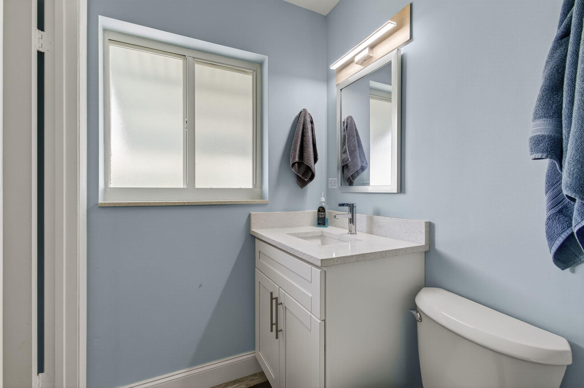 632 Hummingbird Lane Delray Beach, FL 33445 - Photo 47 of 60 a bathroom with a toilet sink and mirror
