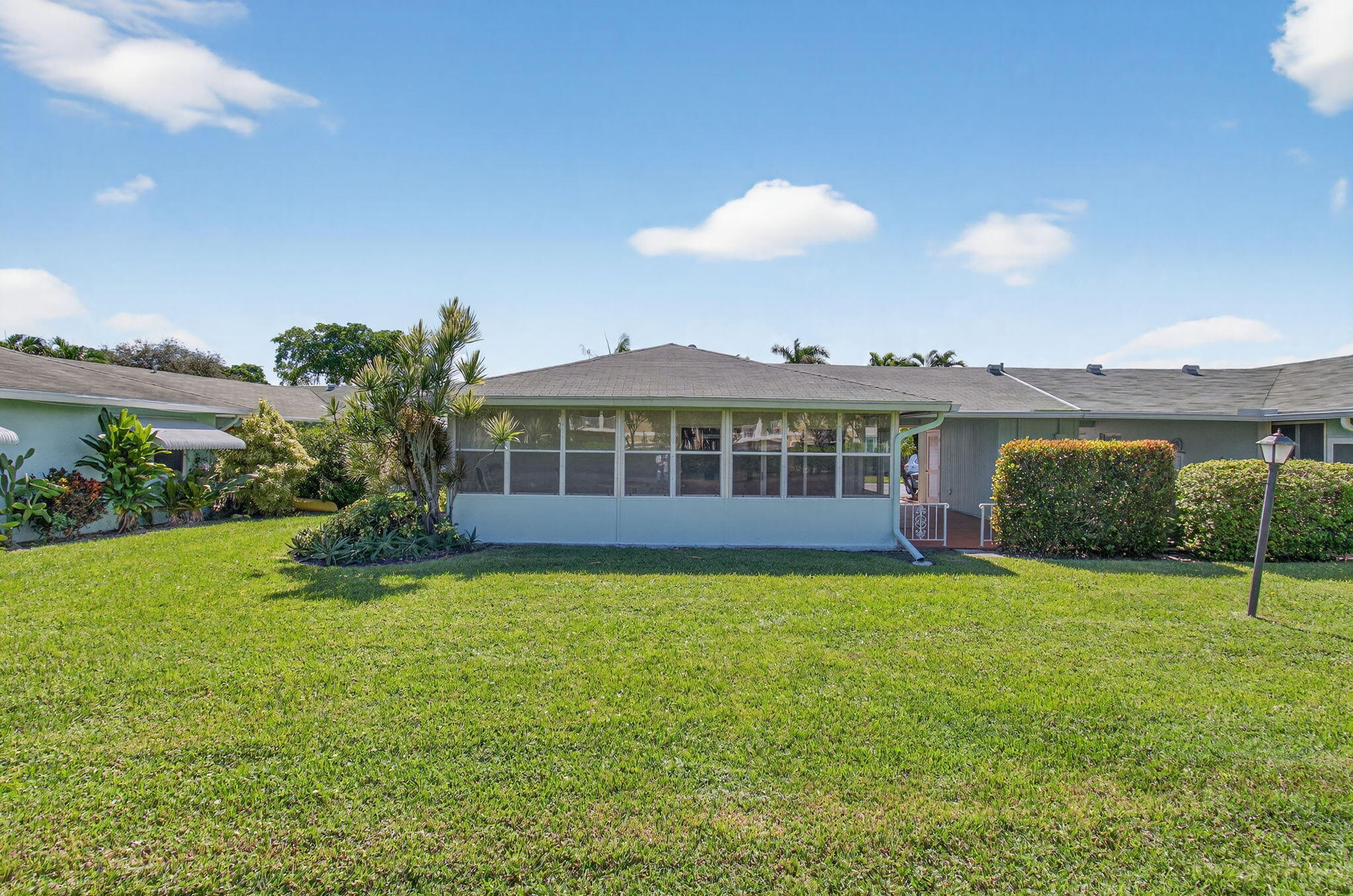632 Hummingbird Lane Delray Beach, FL 33445 - Photo 59 of 60 a view of a house with a yard table and chairs