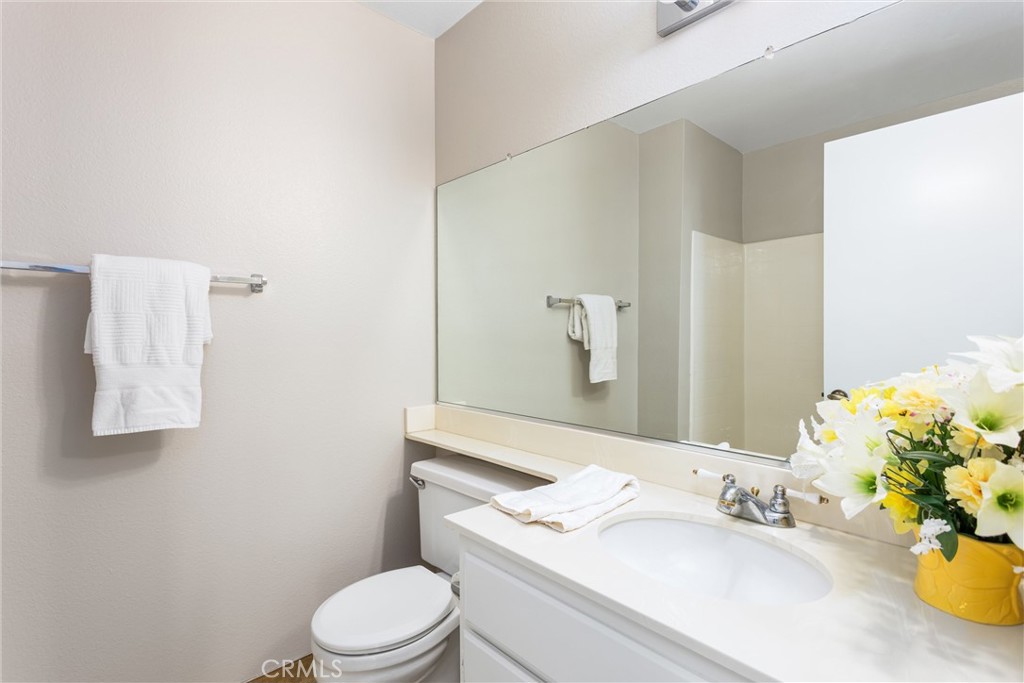 680 Indian Wells Road Banning, CA 92220 - Photo 18 of 37 a bathroom with a sink vanity mirror and toilet