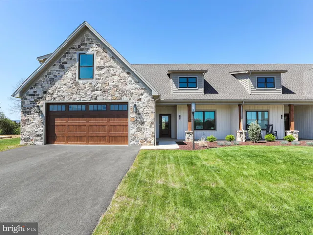 a front view of a house with swimming pool having outdoor seating