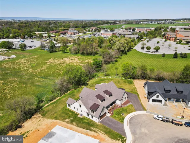 a large kitchen with stainless steel appliances granite countertop a sink a stove and a refrigerator