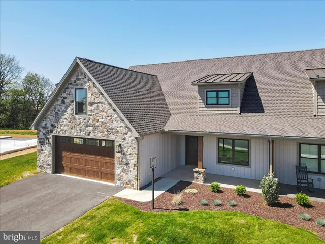 a kitchen with granite countertop a sink stove and cabinets