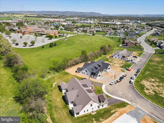 a large kitchen with granite countertop a stove top oven a sink a dining table and chairs