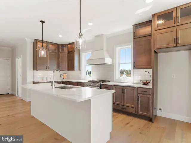 a kitchen with a sink chandelier and fireplace