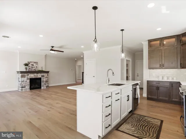 a kitchen with stainless steel appliances granite countertop a sink a stove and a refrigerator