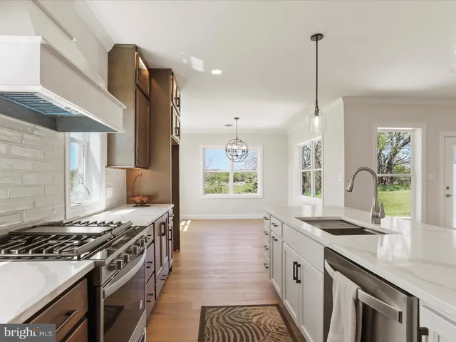 a view of a room with wooden floor and window