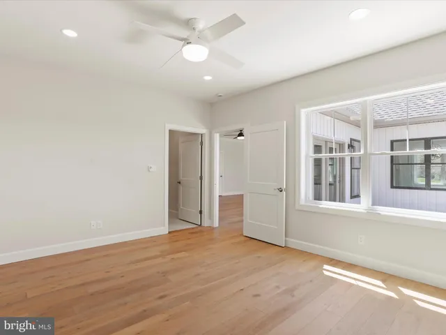 a bathroom with a granite countertop sink a toilet and a mirror