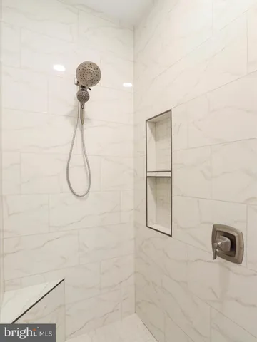 a bathroom with a granite countertop toilet a sink and a mirror
