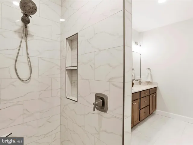 a view of an empty room and a ceiling fan