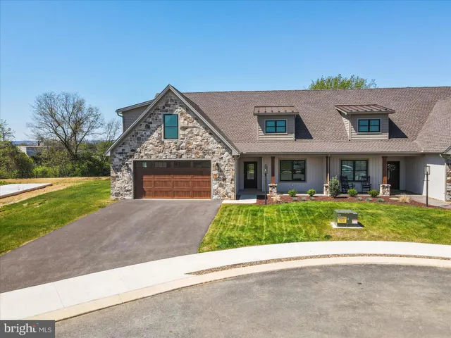 a view of a house with a yard and sitting area