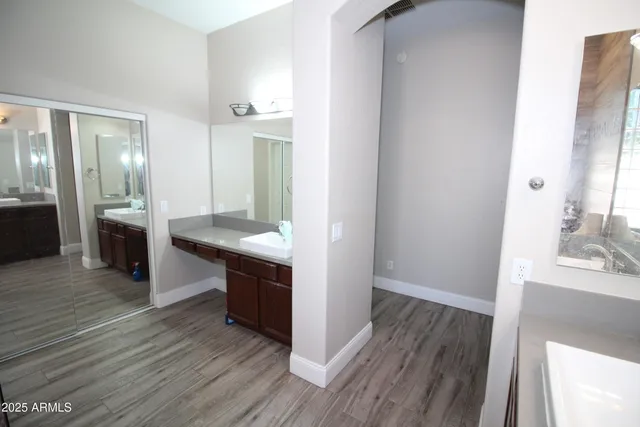 a large kitchen with granite countertop a large counter top space and stainless steel appliances