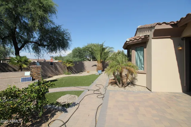 a view of a house with a yard and potted plants