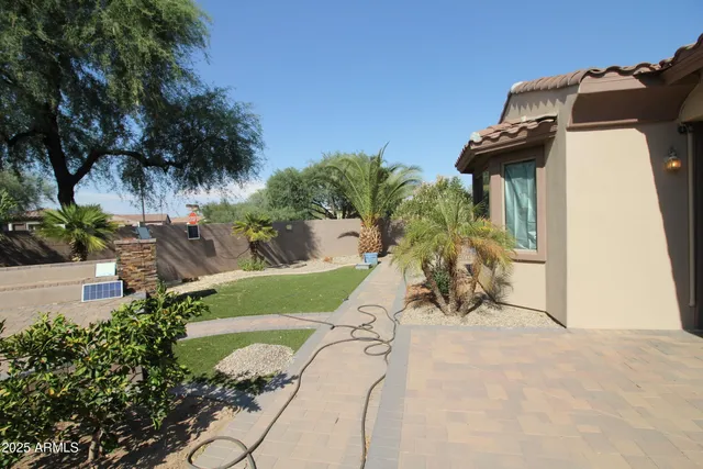 a view of a house with a yard and sitting area