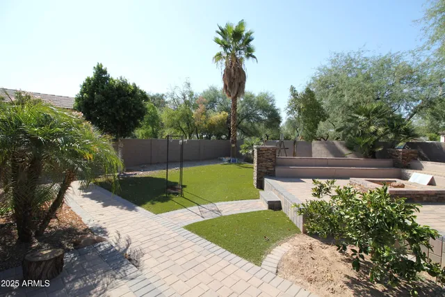 a view of a house with a yard and sitting area
