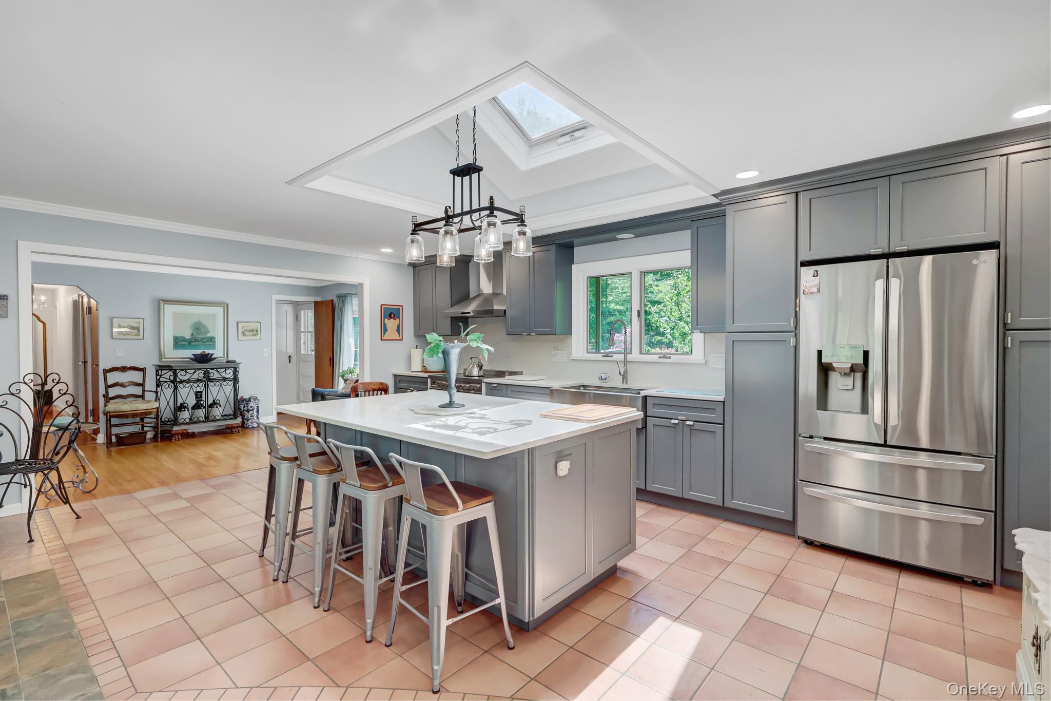 100 Elwood Road Northport, NY 11768 - Photo 6 of 39 Kitchen featuring a skylight, recessed lighting, and a kitchen island with seating