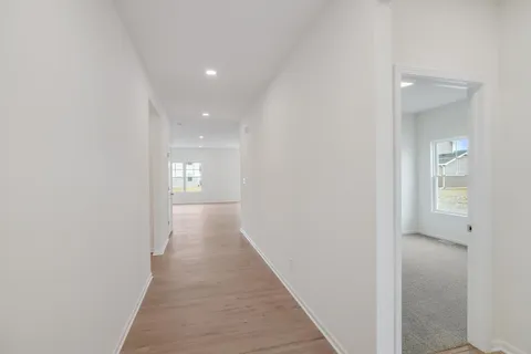 a view of a hallway with wooden floor