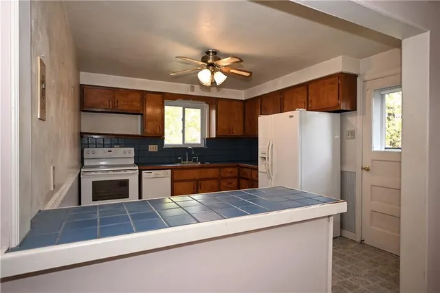 a kitchen with cabinets and stainless steel appliances