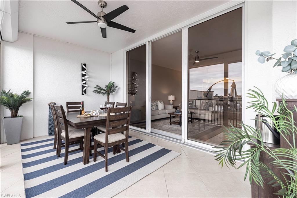 a dining room with furniture and floor to ceiling window