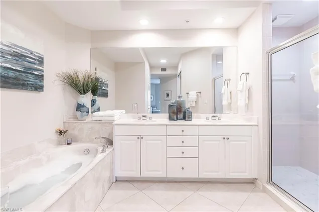 a bathroom with a bathtub sink and mirror