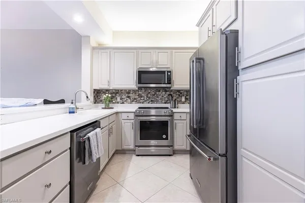 a kitchen with a sink stove and refrigerator