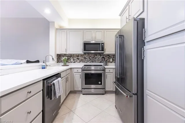 a kitchen with a sink stove and refrigerator