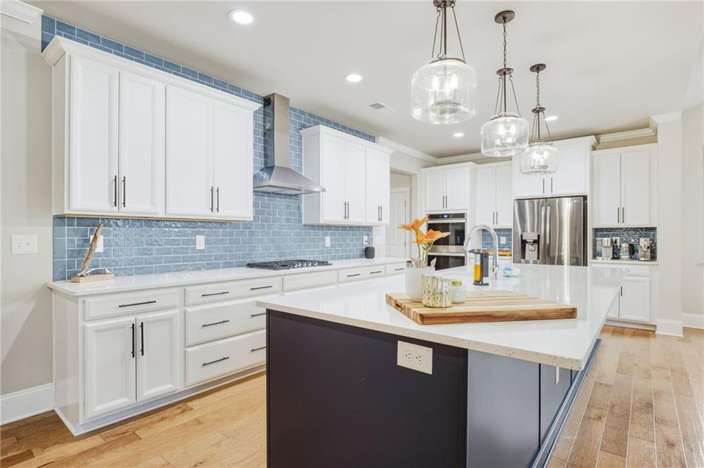 265 Fountain Oak Way Canton, GA 30114 - Photo 11 of 59 a kitchen with kitchen island granite countertop a sink cabinets and stainless steel appliances