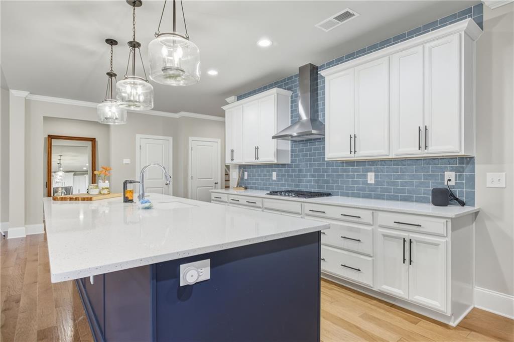 265 Fountain Oak Way Canton, GA 30114 - Photo 13 of 59 a kitchen with kitchen island granite countertop a sink a center island and cabinets