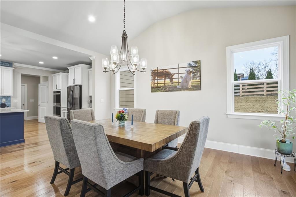 265 Fountain Oak Way Canton, GA 30114 - Photo 18 of 59 a view of a dining room with furniture wooden floor and chandelier