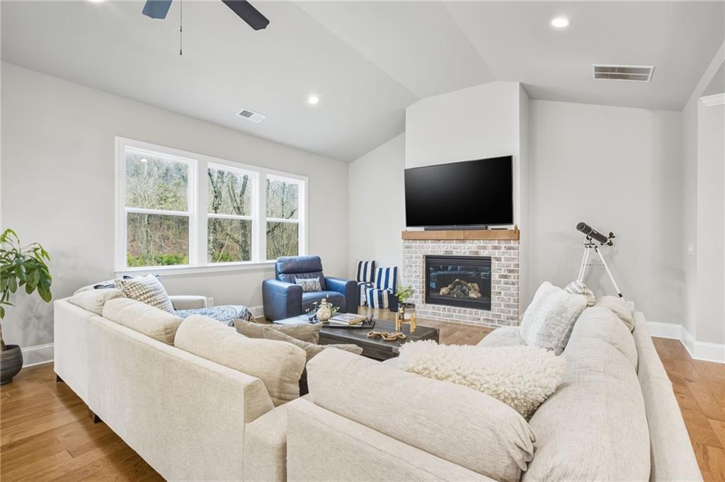 265 Fountain Oak Way Canton, GA 30114 - Photo 21 of 59 a living room with furniture a fireplace and a flat screen tv