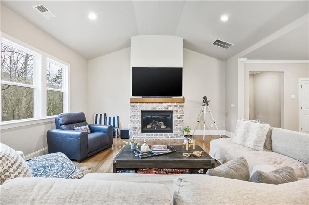 265 Fountain Oak Way Canton, GA 30114 - Photo 22 of 59 a living room with furniture a fireplace and a flat screen tv